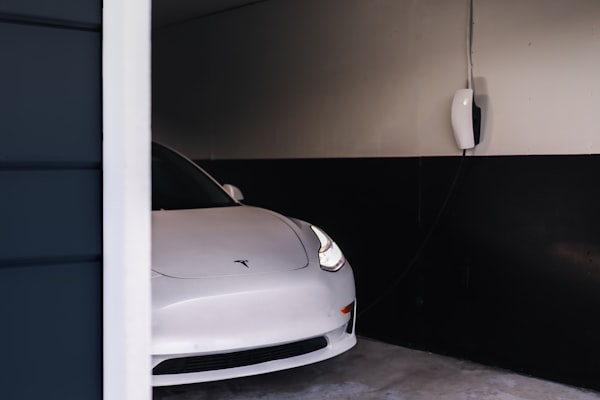 Tesla in garage with wall charger installed